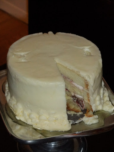 The first (and only) slice was cut. You can actually see the indents on the top where our cake topper was placed.