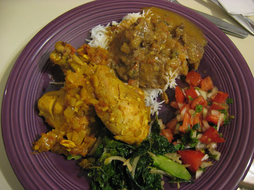 The final result (clockwise from top): the lamb madras on steamed basmati rice, a simple tomato and onion salad or cachumbar, the kale side, and the chicken tikka masala.