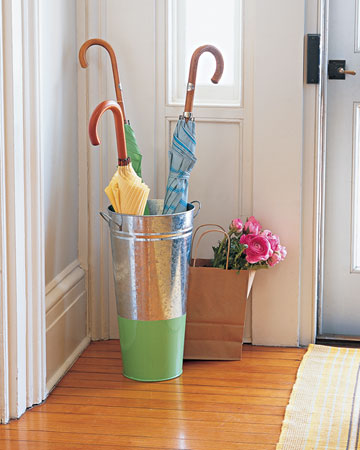 This umbrella stand is actually made from a flower bucket which has been painted on the bottom. It's a more colorful, DIY option. This umbrella stand is actually made from a flower bucket which has been painted on the bottom. It's a more colorful, DIY option.
