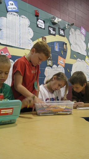 A few of the many children involved in a coloring activity that takes much patience and cooperation. (Photo by: Brittni Bynum)