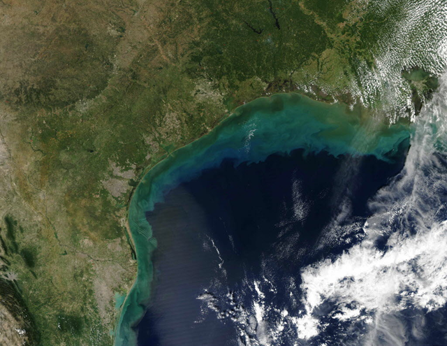 This image provided by NASA shows sediments in the Gulf of Mexico taken by the Aqua satellite in Sept. 2002. Nitrogen and phosphorus pollutants from the farms end up on a huge scale in the Gulf, where an 8,000-square-mile dead zone forms annually off the Louisiana and Texas coasts as one result. AP Photo / NASA