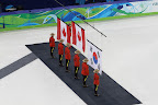 Flags being raised during O Canada for the men's 500m short track medal ceremony