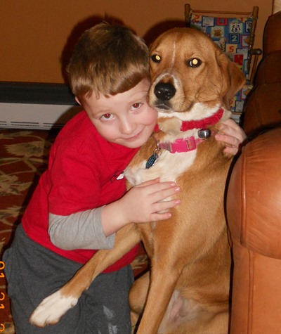 boy hugging dog