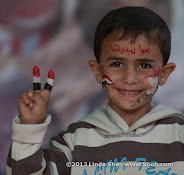 The writing on Abdullah's forehead says: "Together we build Yemen",  Change Square, Sana'a, Yemen. ساحة التغيير بصنعاء اليمن