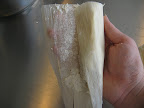 Fold one edge f the corn husk over the tamale