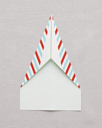 Fold corners in a second time, bringing upper sides to meet at the middle. Fold corners in a second time, bringing upper sides to meet at the middle.