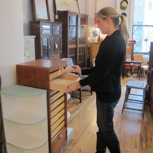 Decorating & Home Editor Rebecca Robertson inspects the drawers of a very unique wooden piece that we both loved.