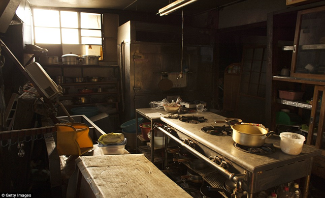 Derelict: A restaurant kitchen in Minamisoma, Japan, sits empty, a pot still on the burner, within the exclusion zone, some 12 miles from the Fukushima nuclear power plant, 12 April 2011. Getty Images / dailymail.co.uk