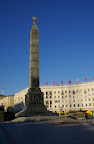 Victory Monument from the ground with the "eternal flame", just visible in the foreground on the right.