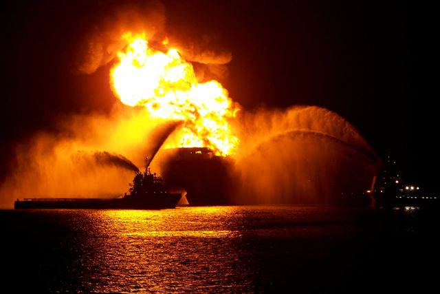 The Deepwater Horizon oil rig burns in the night. Photo: Matt Milbury / Piping Designer