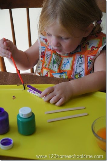 Preschooler painting her airplane Preschooler painting her airplane
