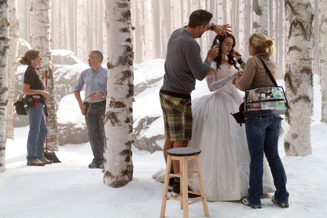 Snow dresser Claire Belisle and prop man Denis Hamel talk while Lily Collins is groomed, "Snow White," September 13, 2011