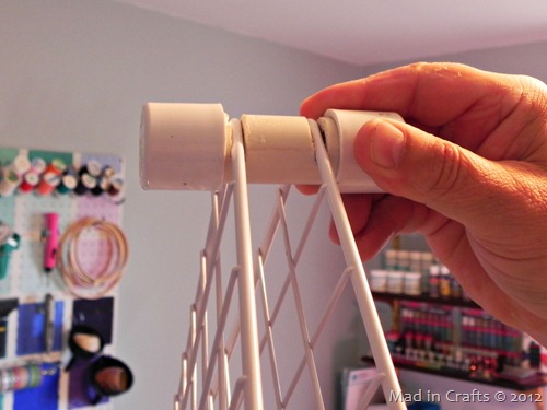 man's hand holding rack spacers made from pvc