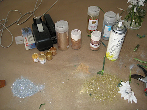 The glitter, luster dust, and spray we used for the bouquet. We put down kraft paper first, which we recommend as it makes clean up much easier.