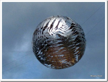 Suspended sculpture of NZ fern fronds behind the Micheal Fowler centre.