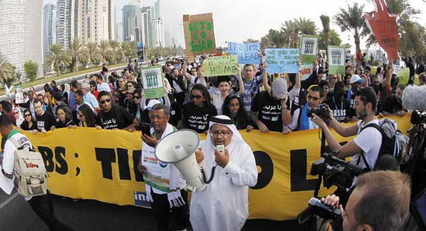 Local and international activists march to demand action on climate change at the U.N. climate talks in Doha, Qatar, 1 December 2012. AP Photo