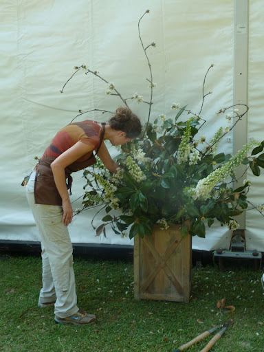 Heather adjusts a large arrangement.