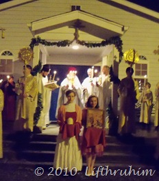 Standing in front of the Chapel while the Gospel is read.