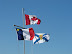 Acadian, Canadian, and Nova Scotian flags.