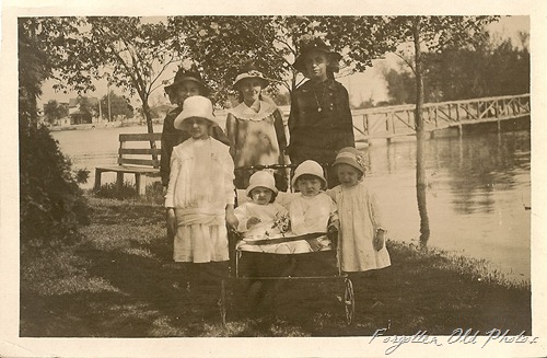 Children with hats by river Solway