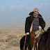 Kazakh camel herder on the plane above Dabancheng
