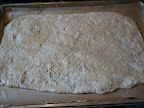 Lightly pat the dough out and brush with mustard.