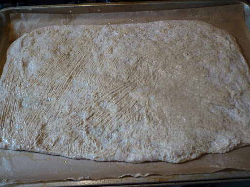 Lightly pat the dough out and brush with mustard.