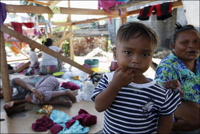 Typhoon Haiyan survivors rest at a temporary shelter in Tanauan, Leyte, in central Philippines on 7 November 2014. Photo: Erik de Castro / Reuters