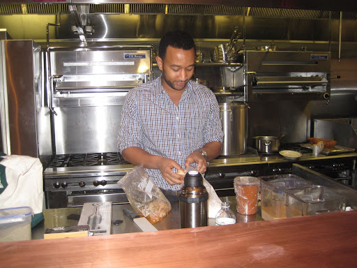 John Legend preparing his fried chicken for the 