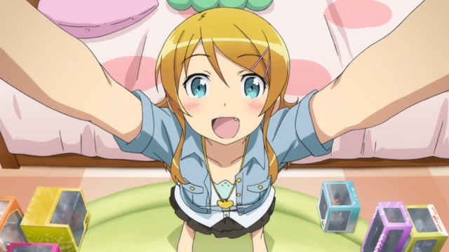 Top-down view of Kirino in a victory stance, arms raised and head up, in her room with figurine boxes all over the floor