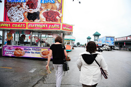 KSMU's Michele Skalicky and Lisa Brenneman walk down the street lined with vendors waiting to be inspected. Photo Credit: Alex Crowder