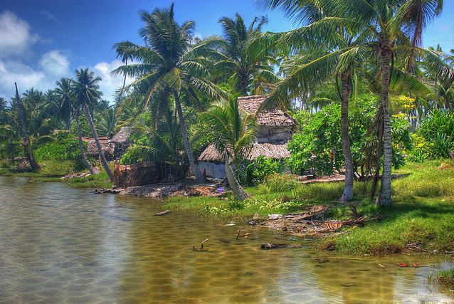 The rising ocean encroaches on a village in Kiribati, 13 March 2007. Herve Damlamian /  flickr