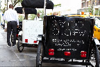 Rickshaws were stationed outside of the store with Rickshaws were stationed outside of the store with