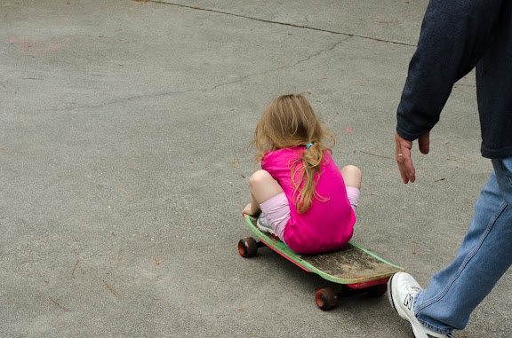Papa teaching Sam about the skateboard