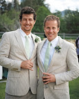 A pair of groomsmen mug for the camera in suave striped suits. Groom Peter gave them all custom Nike sneakers that sported the wedding date and each man's last name. A pair of groomsmen mug for the camera in suave striped suits. Groom Peter gave them all custom Nike sneakers that sported the wedding date and each man's last name.