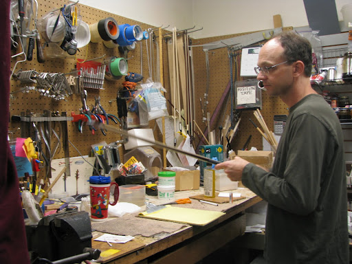 Owner Brian Hoover repainting a violin bow. (Photo credit: Rebekah Clark)