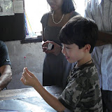 Kai marveling at a freshly crafted bead