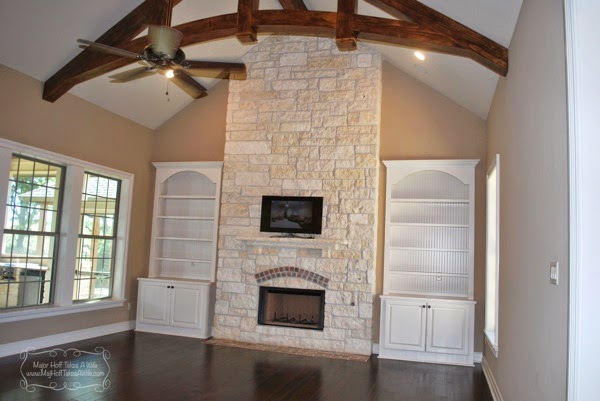 White beadboard bookcase cabinets flanking austin stone full fireplace.jpg White beadboard bookcase cabinets flanking austin stone full fireplace