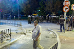 Casual stroll. Note cracked pavement, pulled apart for projectiles by some in the crowd.