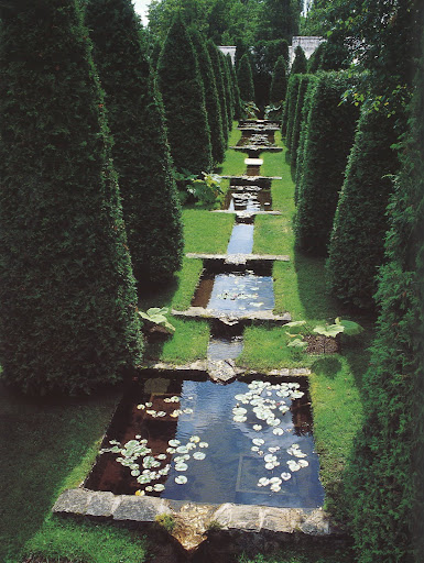 The Watercourse,  a series of pools and canals framed by shaped thuja.