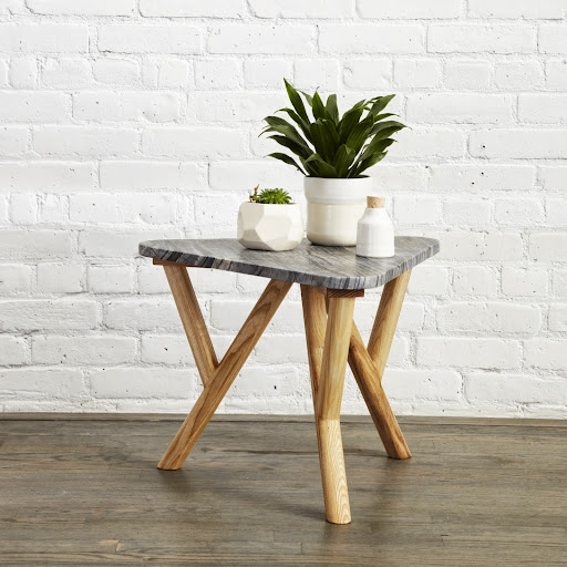 The end table is available in white, green, grey (shown), and black marble.