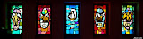 The middle window shows a small vessel under full sail. This is an ancient symbol of the church; the universal fellowship of Jesus-believers.
The other 4 windows represent the 4 evangelists, Matthew, Mark, Luke and John. StainedWindows-0831.jpg