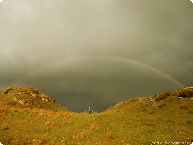 dawn beneath a rainbow at dawn