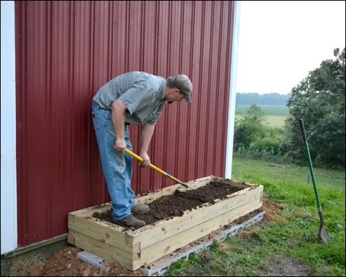 mix and level the dirt in the herb garden mix and level the dirt in the herb garden