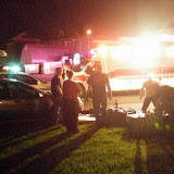 Pella EMTs tend to a motorcyclist that struck a parked car