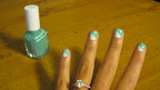 Wait about five minutes for your base color to dry, then use your next color (this will be the middle stripe) and make a diagonal stroke across your nails.
