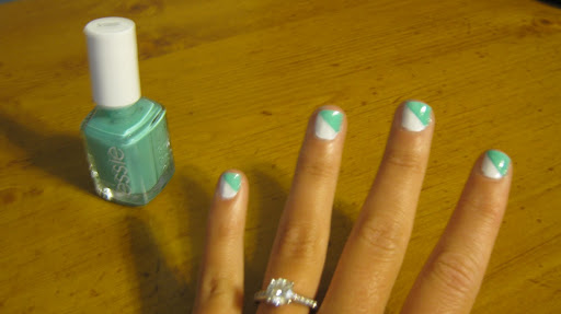 Wait about five minutes for your base color to dry, then use your next color (this will be the middle stripe) and make a diagonal stroke across your nails.