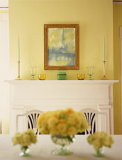 The symmetry of the candlesticks, vases, bowls, and chest gives this mantle a sophisticated and uncluttered look.