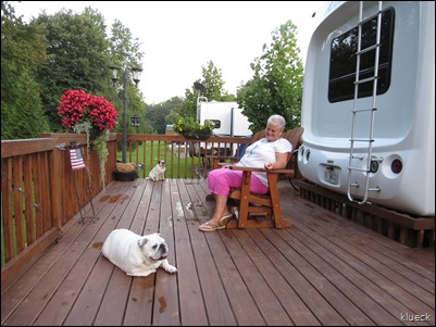 Eileen, dogs and flowers on deck