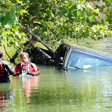 A work truck towing a liquid nitrogen trailer west bound on Garden Highway, became detached from the trailer. The trailer went across Garden Higway, over the side and down into the parking lot below at the Virgin Sturgen where it smashed into a new, parked, Dodge Ram truck and sending the truck across the parking lot and down into the river. The driver of the Dodge truck had left it parked there over night because he had too much to drink at Virgin Sturgen the night before. Twenty-five minutes after the incident, and unaware of it, he came riding up on hist bike to pick up his truck and was wondering what all the fire, police and DART crews were about. He then learned of the incident and called his insurance company. When he realized that the incident could have happened after he was in the truck picking it up, he was very greatful to be alive and that he wasn't in the truck when the incident occured. He stated that his biggest worry for the day now was how he was going to get his bo News_120817_RunawayLiquidNitroTrailer
